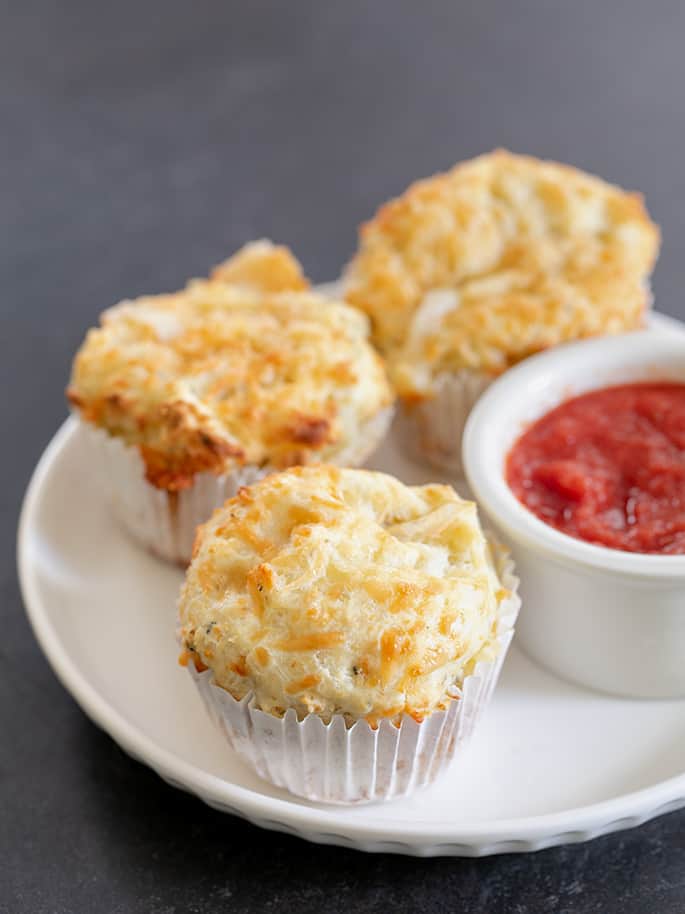 Standard size pizza bites on a plate with sauce