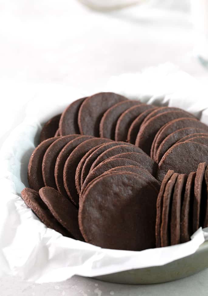 Gluten free chocolate wafer cookies in a pile in white paper