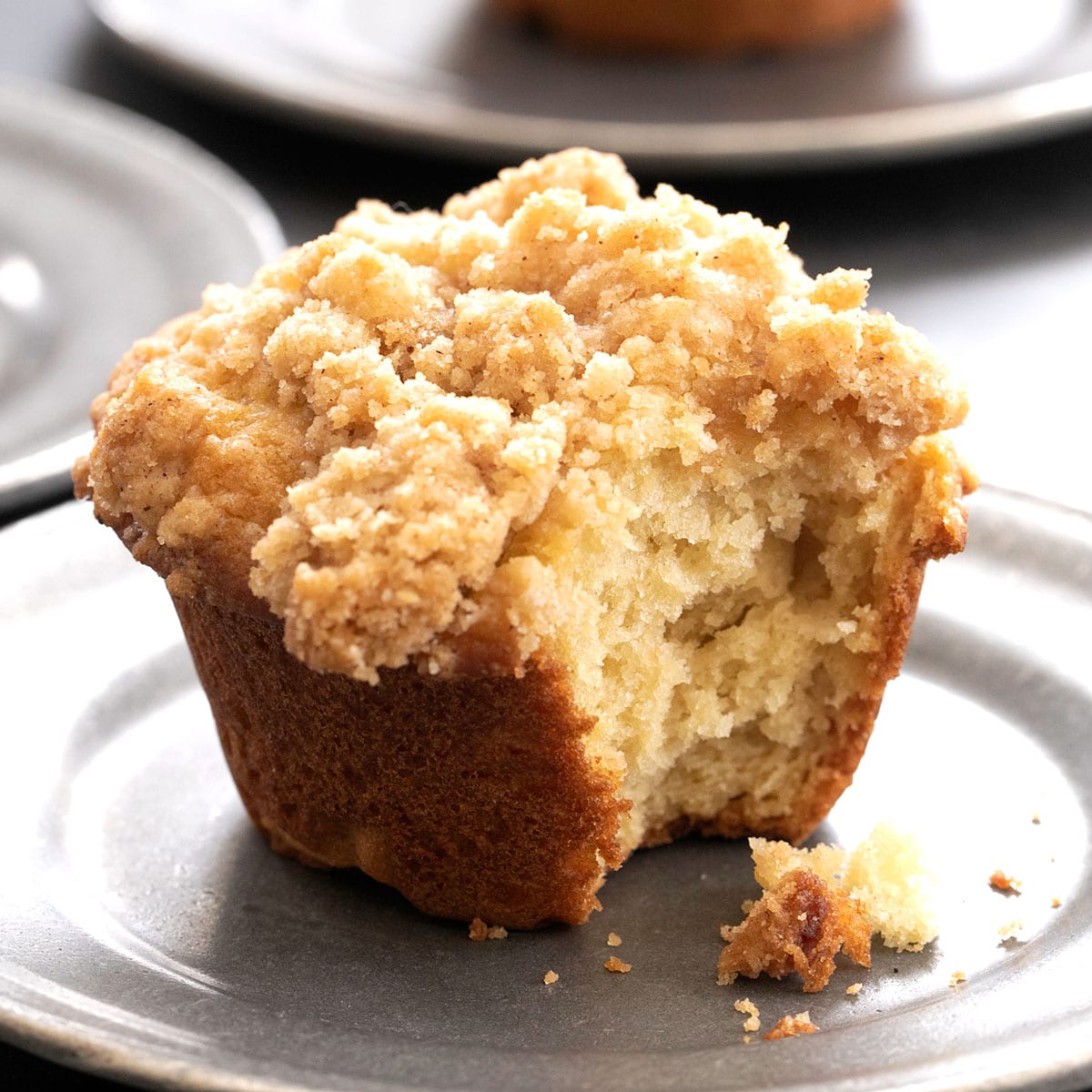 gluten free muffins with crumble topping on small gray plate