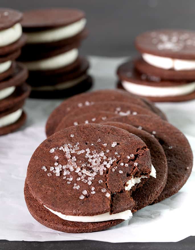 A fallen stack of chocolate cookies with white filling