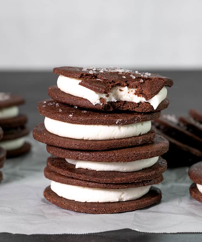 A stack of soft chocolate cookies with white filling