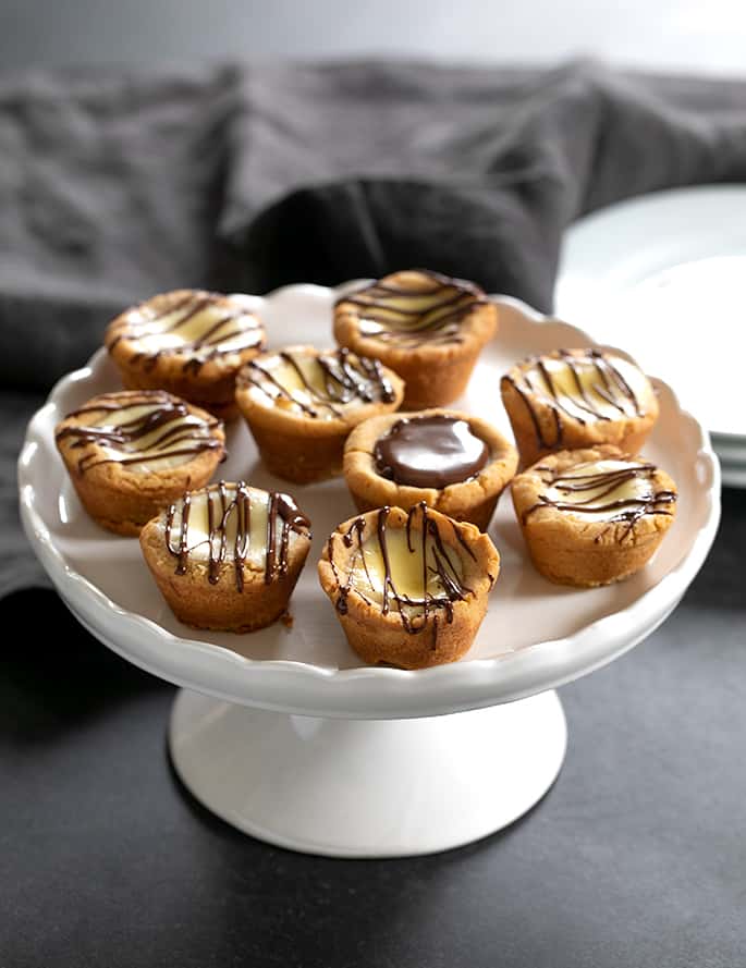 A soft graham cracker crust with the simplest cheesecake filling makes these cheesecake cookie cups the perfect cookie plate surprise.