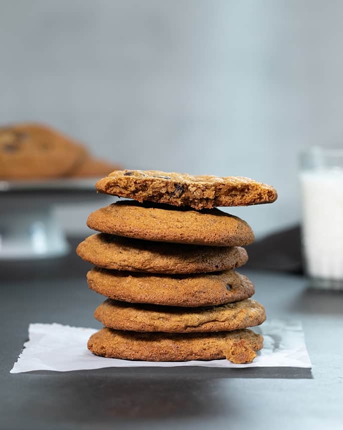 A stack of Paleo chocolate chip cookies with one broken on top