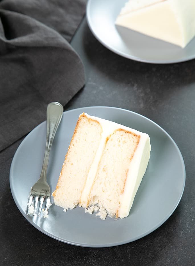 This bakery-style gluten free white cake, made without any egg yolks, is the perfect moist and tender blank canvas to dress up for any occasion.