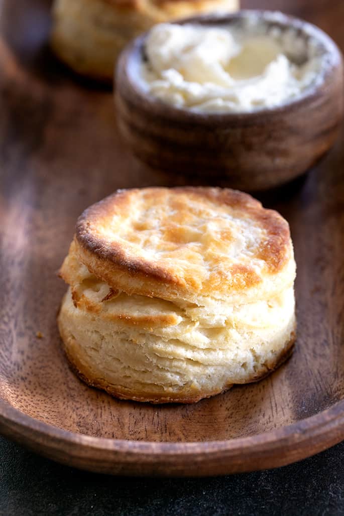 A close up of a layered gluten free biscuit with a brown top