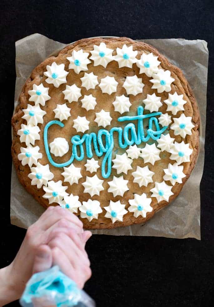 Overhead image of gluten free cookie cake with Congrats written on it in frosting