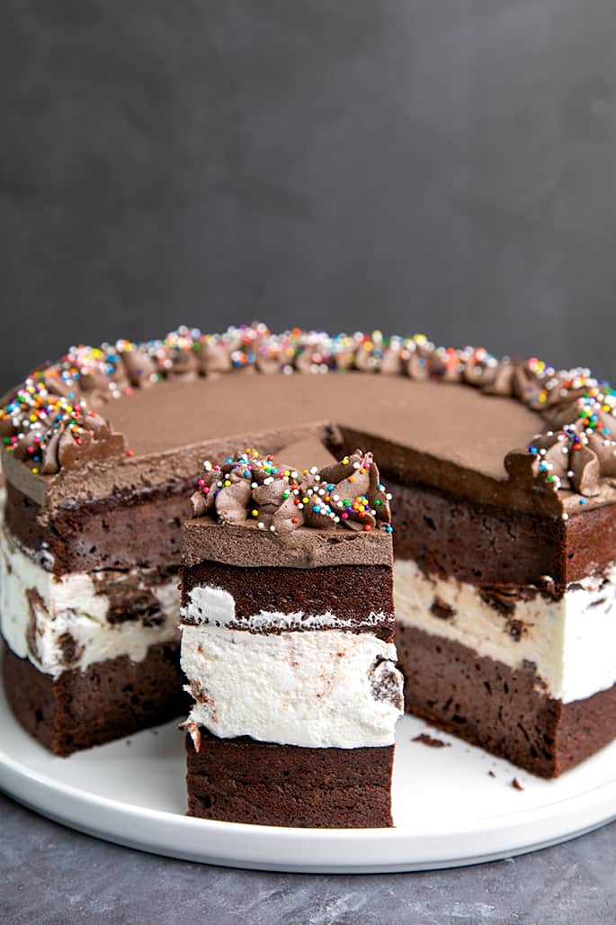 Chocolate layer cake with ice cream in center with slice taken