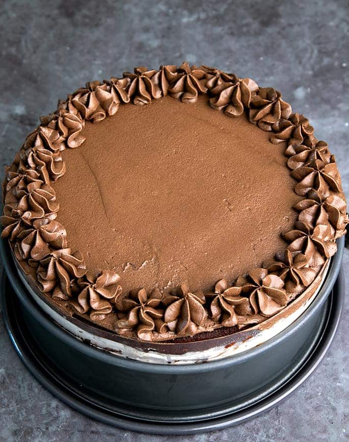 Layer cake with chocolate frosting in springform pan