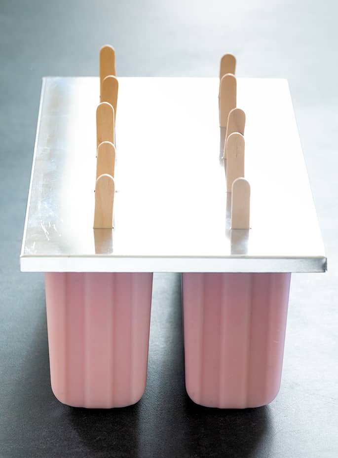 Smooth and creamy, naturally gluten free strawberry yogurt popsicles are perfect for a refreshing breakfast on the go, or an afternoon snack. Make them with fresh or frozen berries.