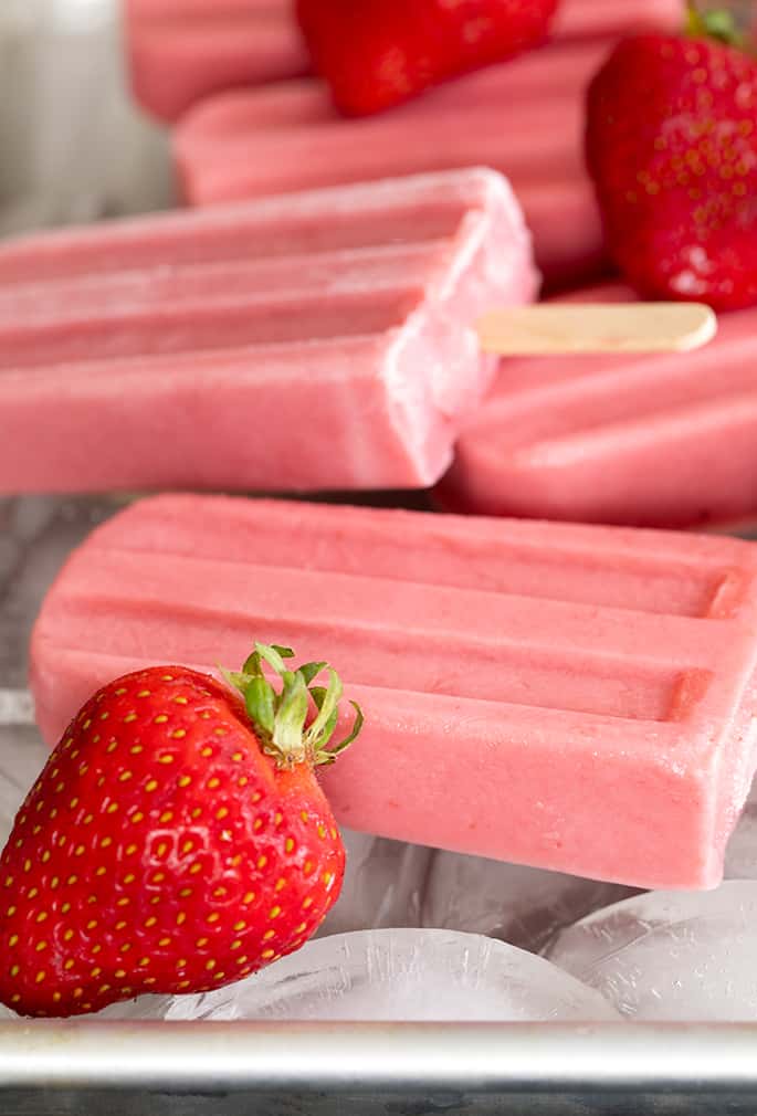 Smooth and creamy, naturally gluten free strawberry yogurt popsicles are perfect for a refreshing breakfast on the go, or an afternoon snack. Make them with fresh or frozen berries.