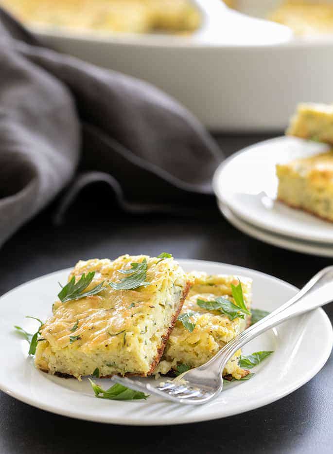 Make good use of that abundant summer squash in this easy recipe for savory gluten free zucchini parmesan squares. Perfect for a picnic lunch or a snack!