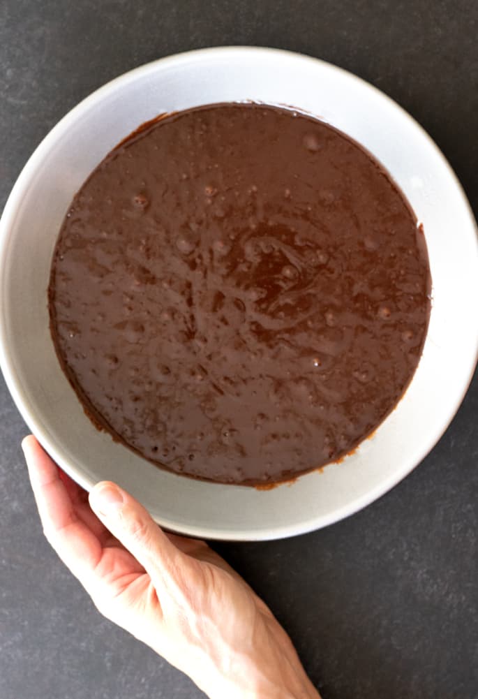 Overhead image of raw brownie batter in pie plate.