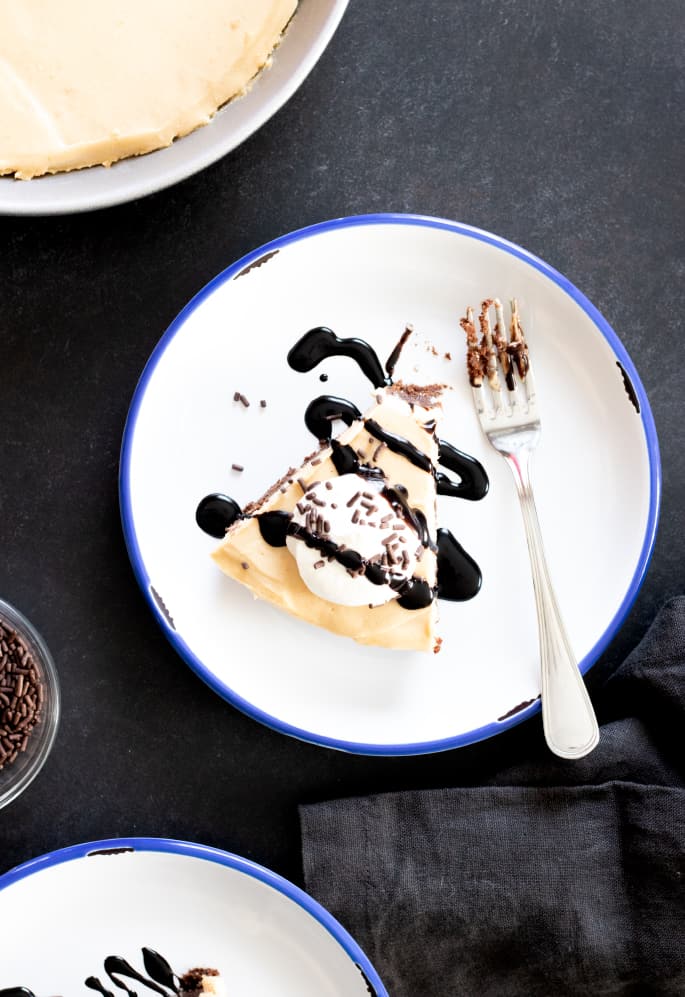 A slice of peanut butter pie on a plate with a fork.