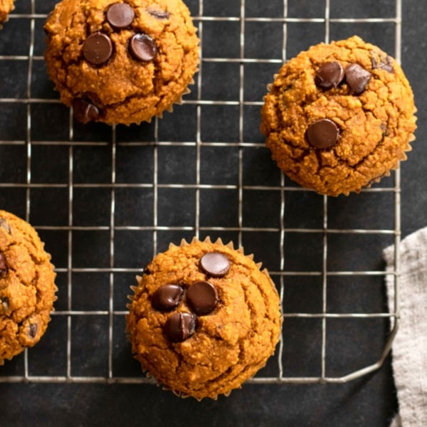overhead image of oat flour pumpkin muffins on wire rack
