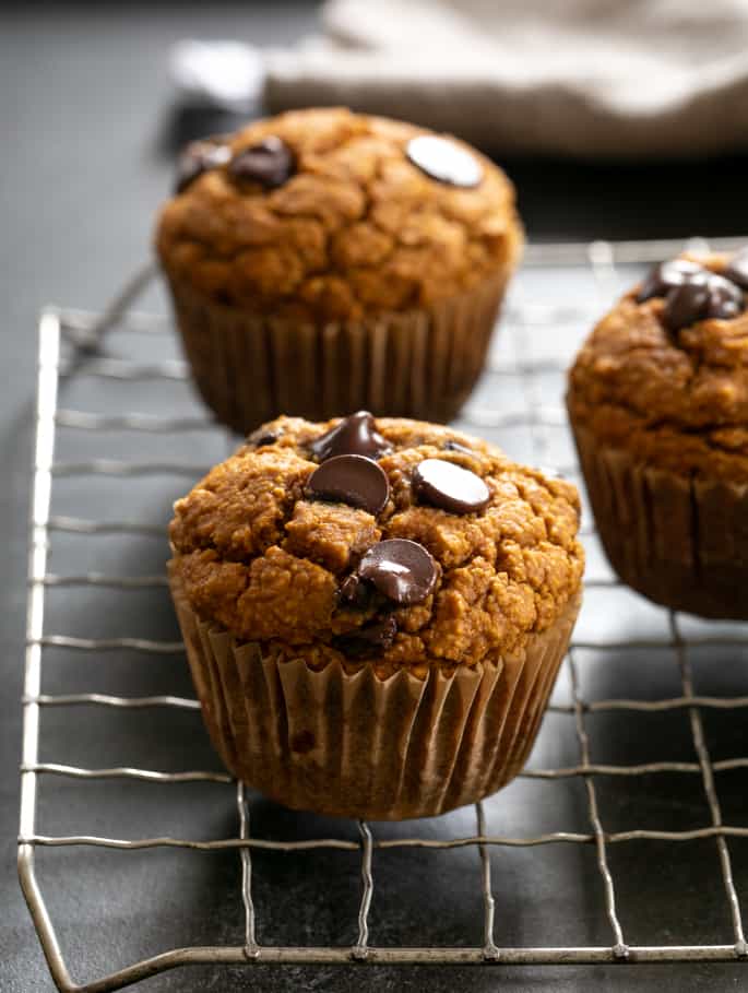 Healthy pumpkin breakfast muffins baked and on a wire rack.