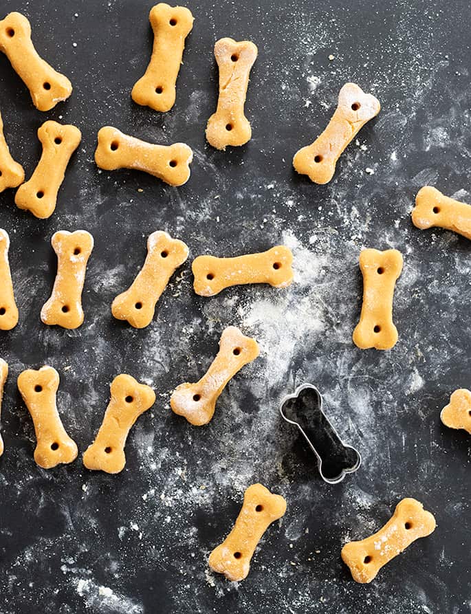 Image of raw, shaped crunchy gluten free dog treats with cookie cutter. 