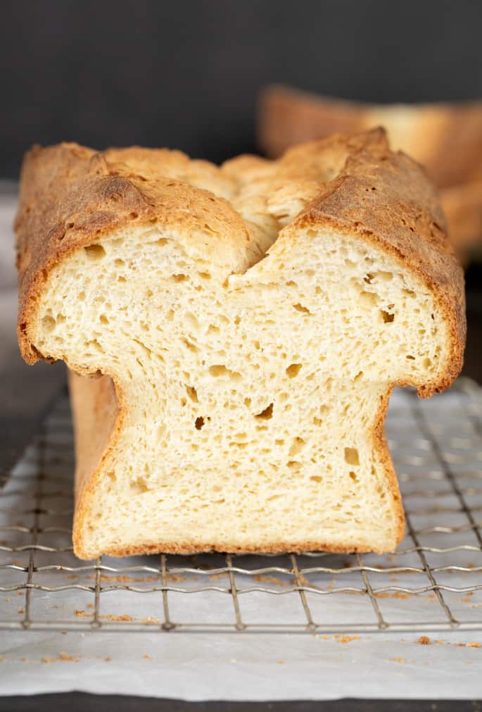 Tom's gluten free sandwich bread shown here sliced, with a clear view of the inside of the loaf of bread.