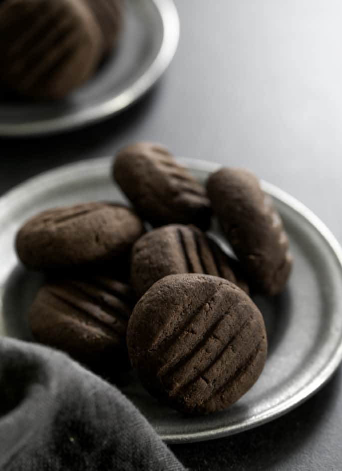 Chocolate gluten free meltaway cookies on a small plate, being served.