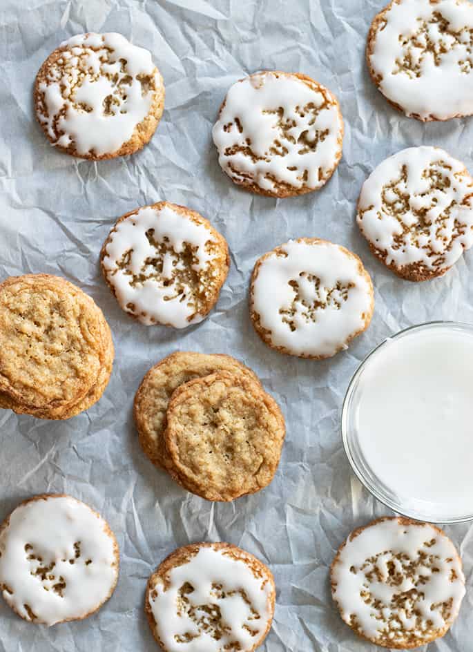 Overhead image of gluten free thin and chewy oatmeal cookies, some iced some plain.