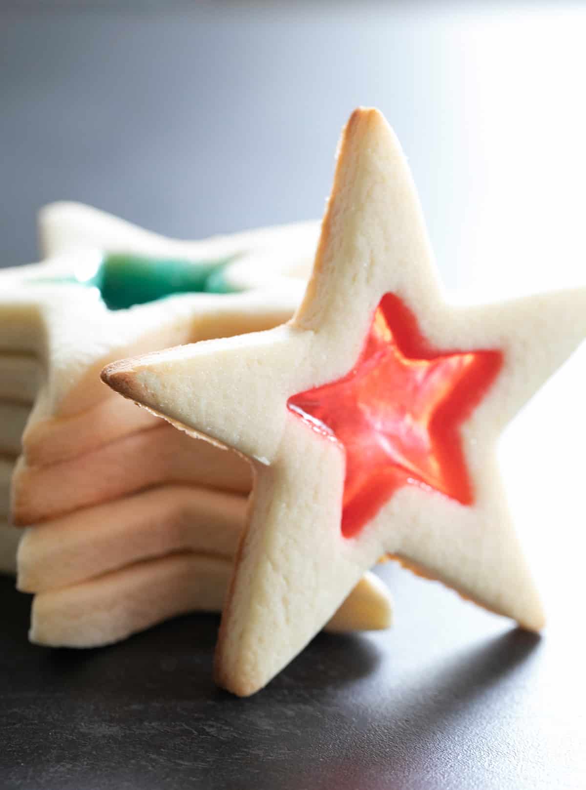 stack of 5 star shaped pale blond cookies with one star with red center candy star standing up