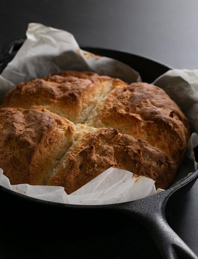 Gluten free savory Irish soda bread baked in pan, just out of the oven. 