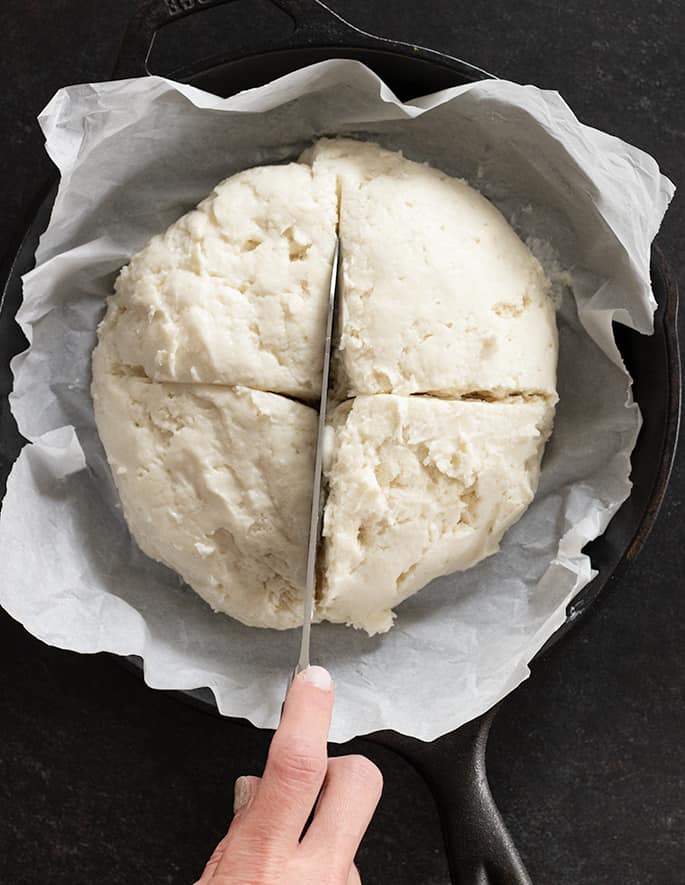 Savory gluten free Irish soda bread raw, being scored for the oven. 