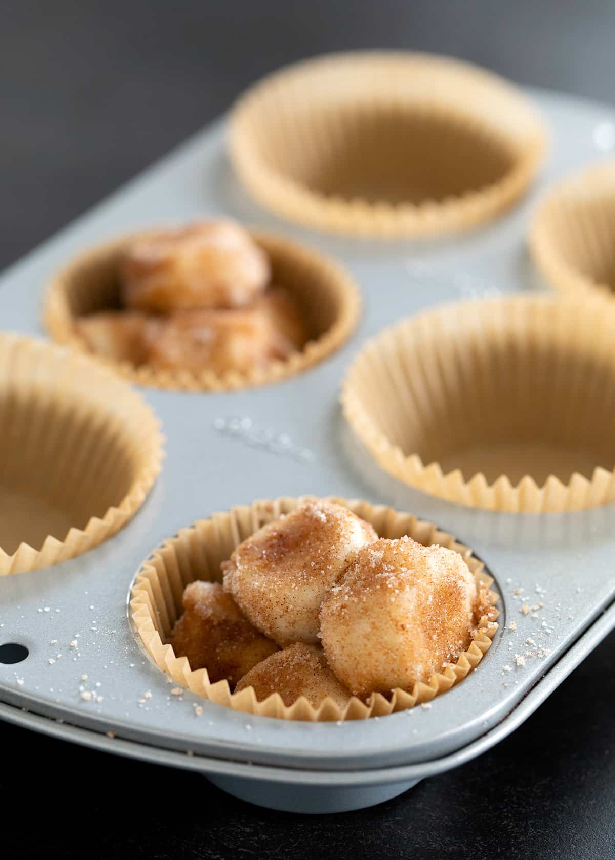 The raw dough in muffin tin, getting ready to go in the oven.