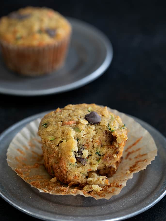 Superfood muffins with the wrapper pulled away and a bite taken, showing the tender inside. 