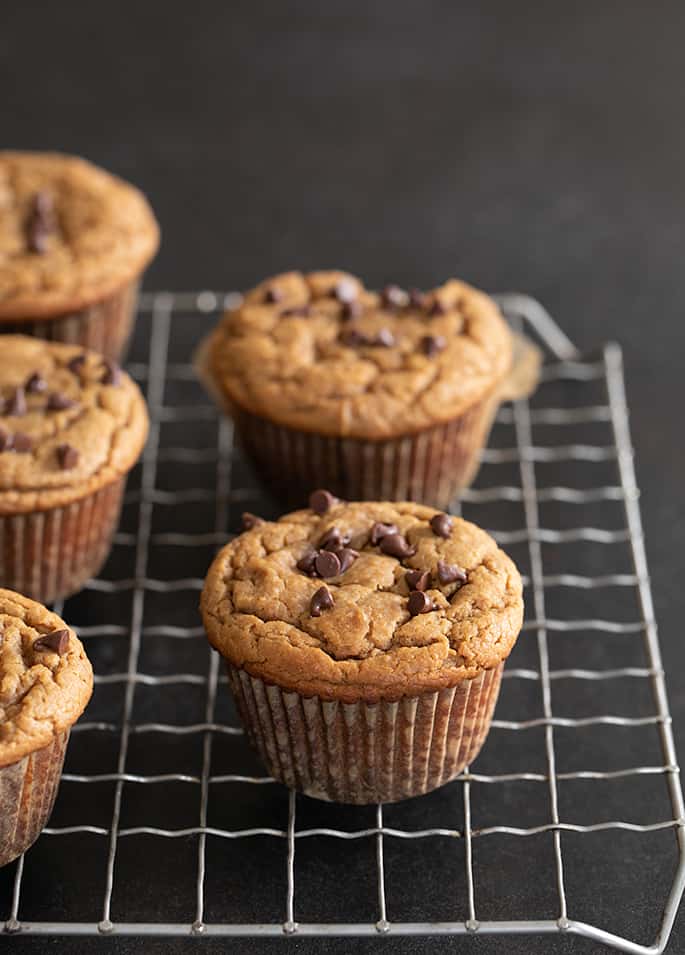 Flourless peanut butter muffins whole muffins on a wire rack.