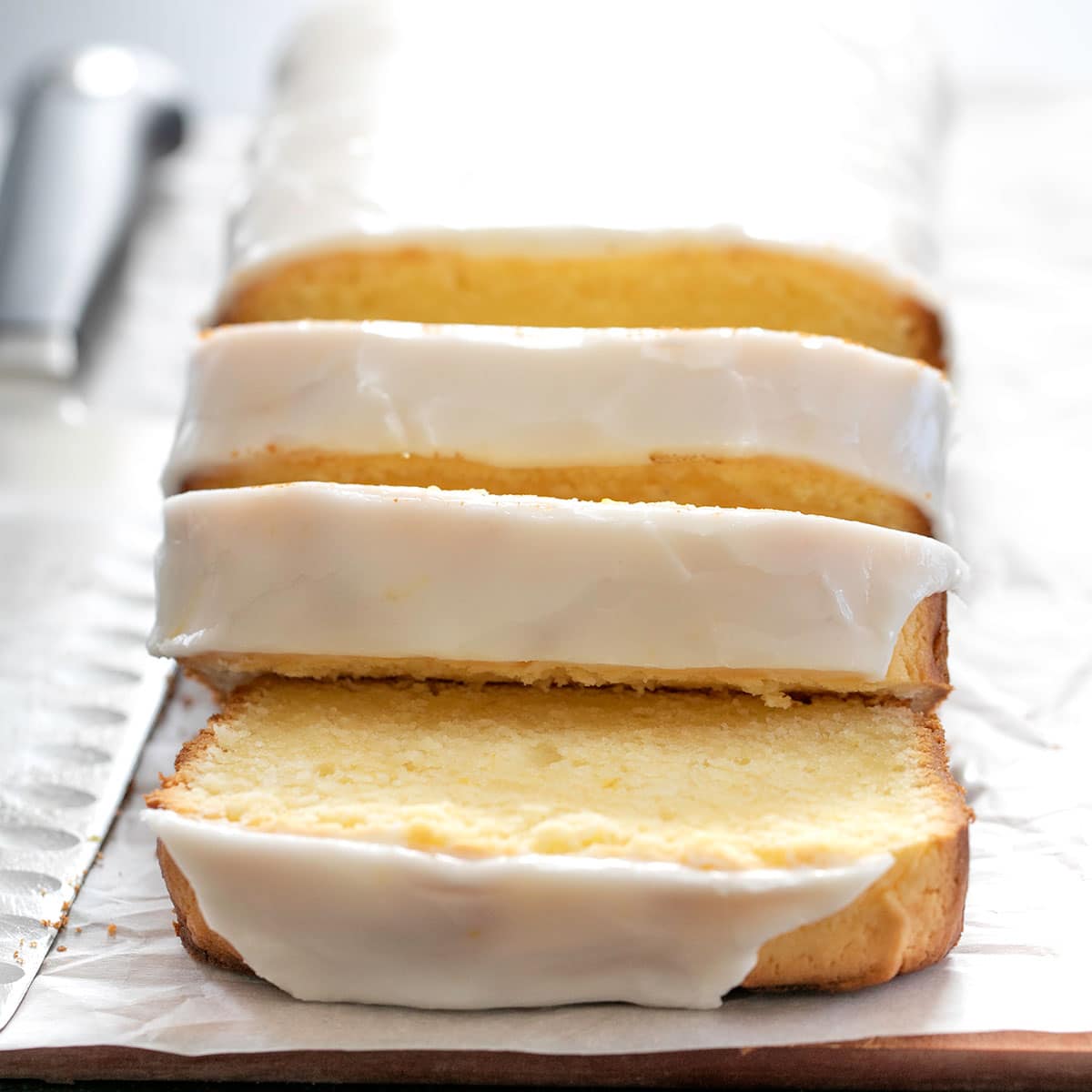 gluten free lemon pound cake with white icing and 3 slices