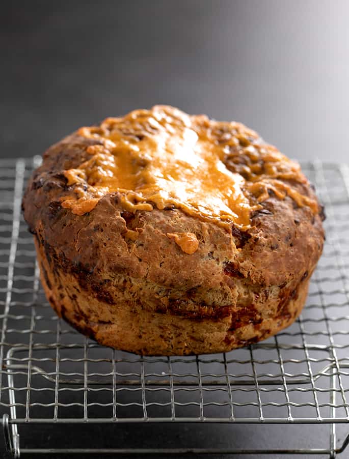 Baked artisan cheese bread cooling on wire rack