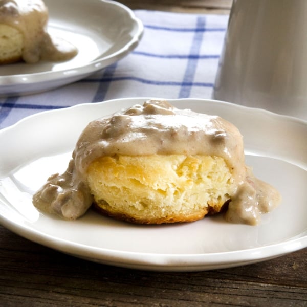 The finished gluten free biscuits and gravy recipe served on a white plate.