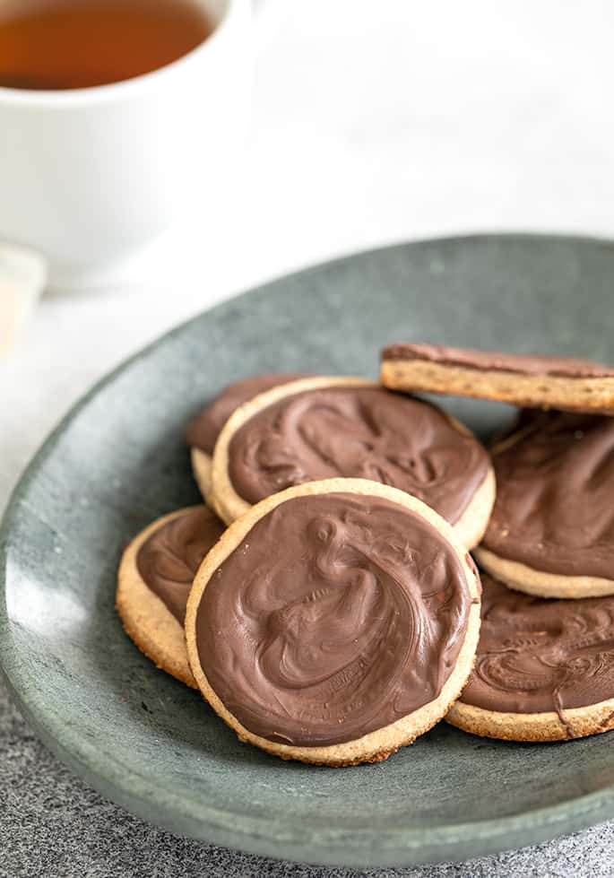 Digestive biscuits with chocolate coating on plate