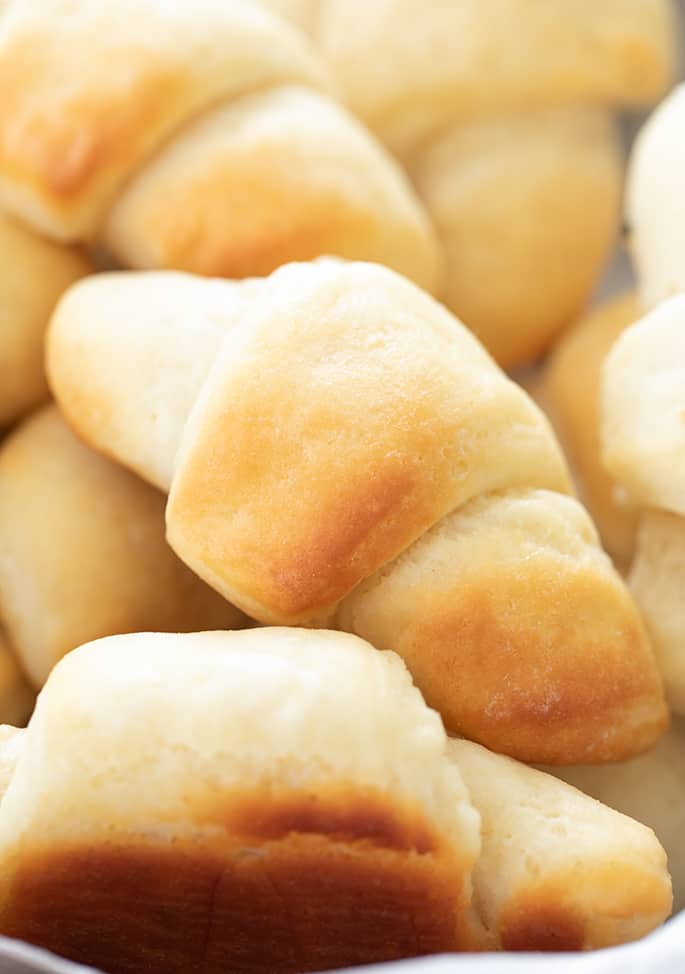 Closeup image of gluten free crescent rolls in a pile