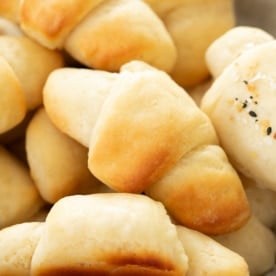 pile of lightly golden browned rolls shaped like crescents