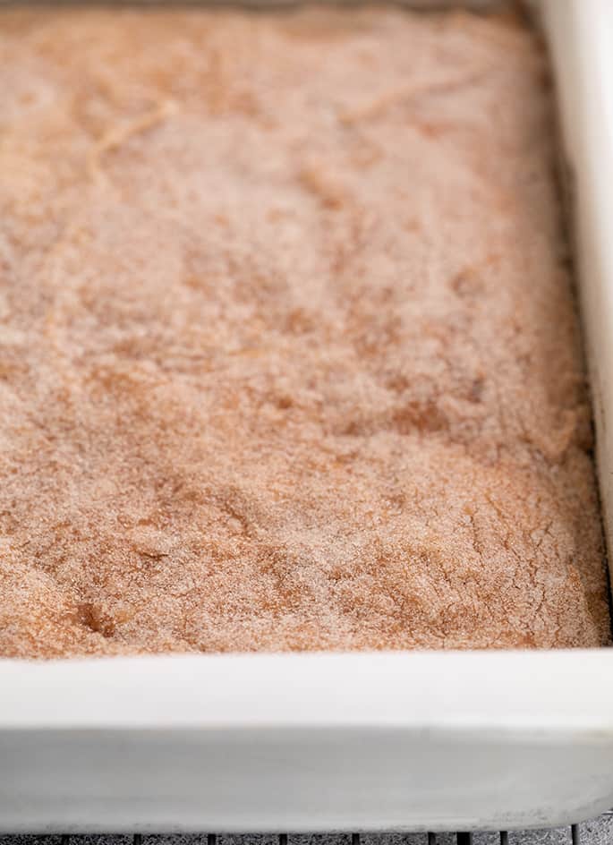 Apple snickerdoodle cookie bars baked in pan on wire rack