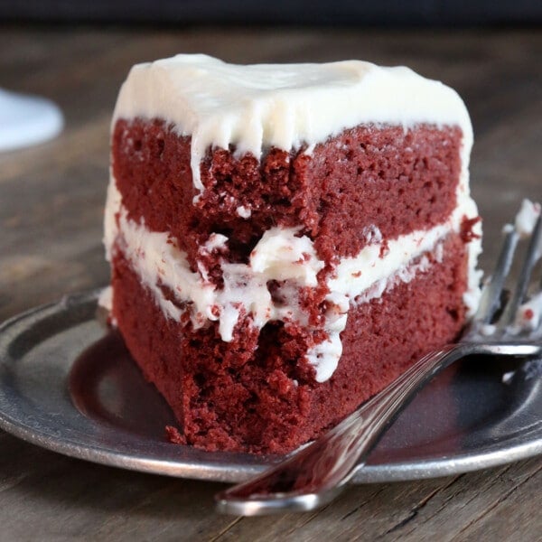 gluten free red velvet cake slice on small plate with fork