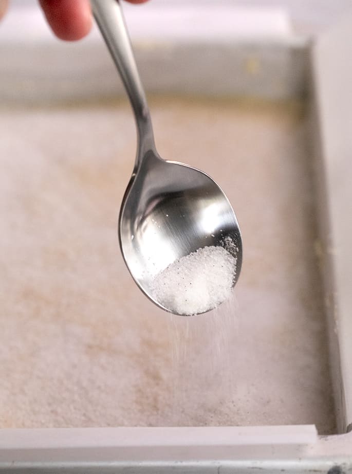 vanilla sugar being shaken from a spoon