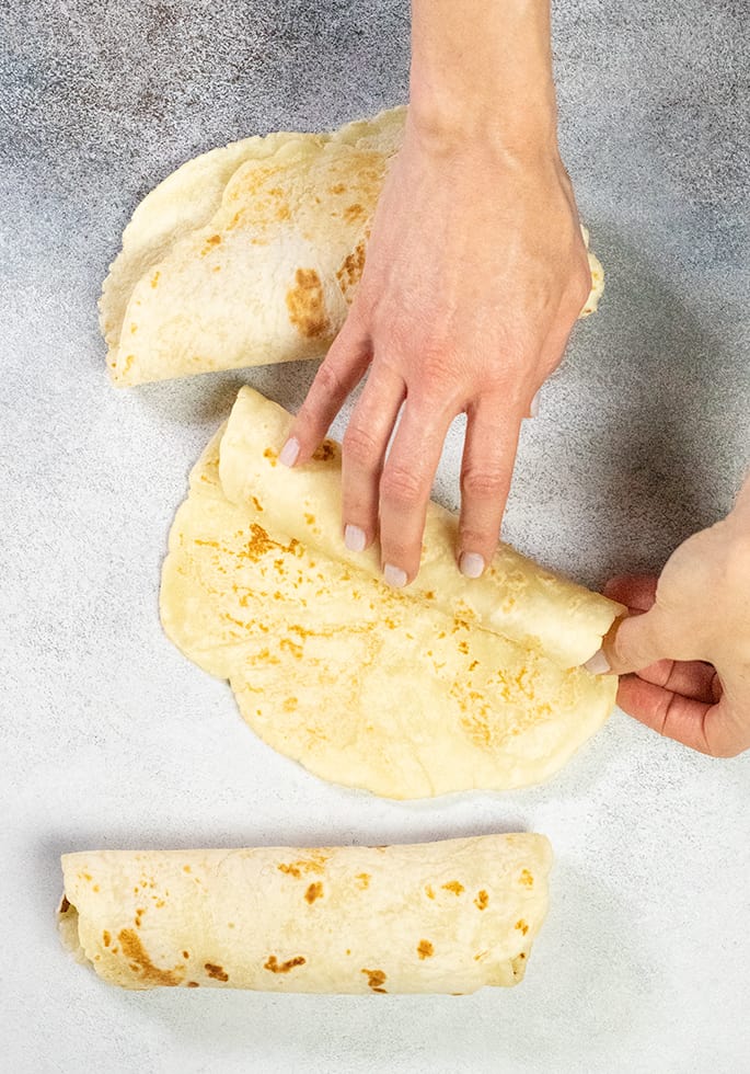 3 flatbreads 1 being rolled by two hands