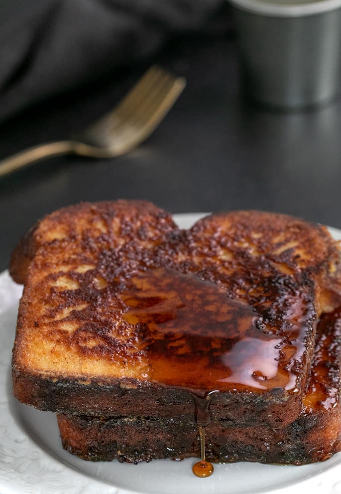 French Toast 2 slices on small white plate with some syrup