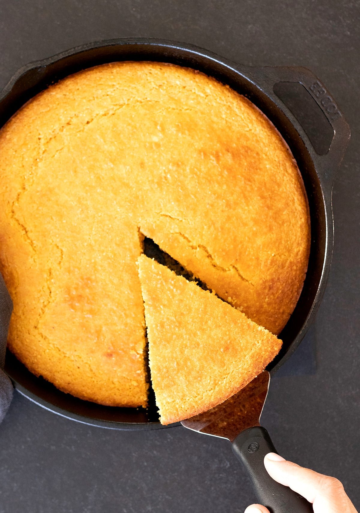 Old fashioned gluten free cornbread corn flour variation, being sliced and served.