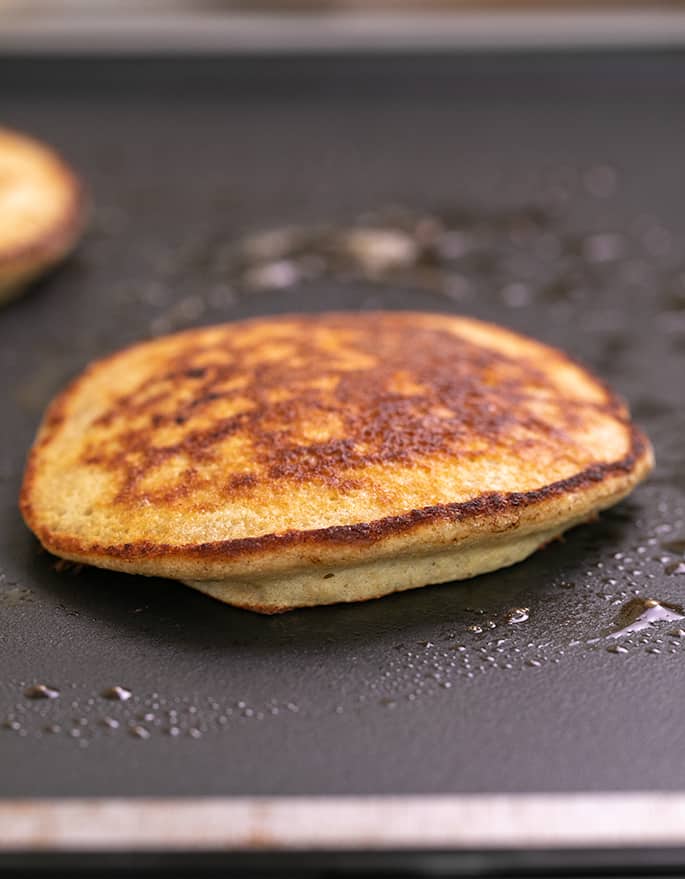 Cooked banana pancake on hot skillet