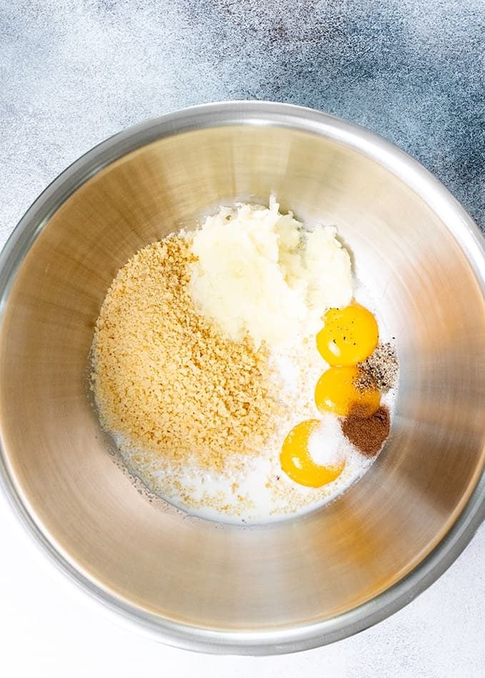 gf breadcrumbs, egg yolks, and spices in a metal bowl