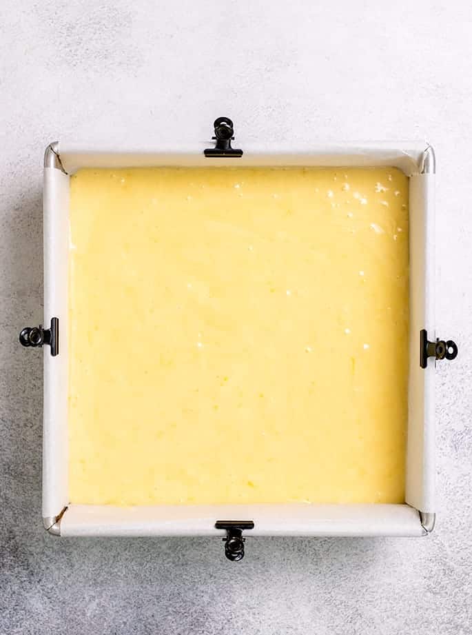 Overhead image of raw lemon brownie batter in square pan