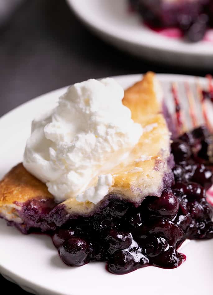 Closeup image of blueberries in sauce with some pie crust on top