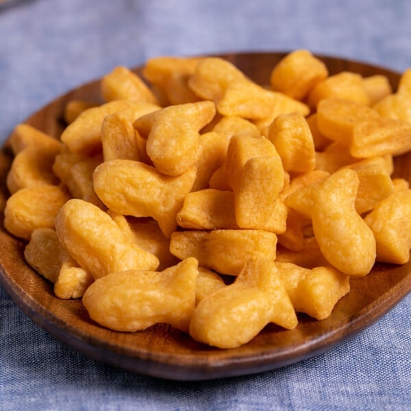 gluten free goldfish crackers on brown plate on blue cloth