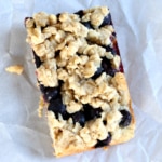 overhead view of crumble topping and blueberries on blueberry oat bar