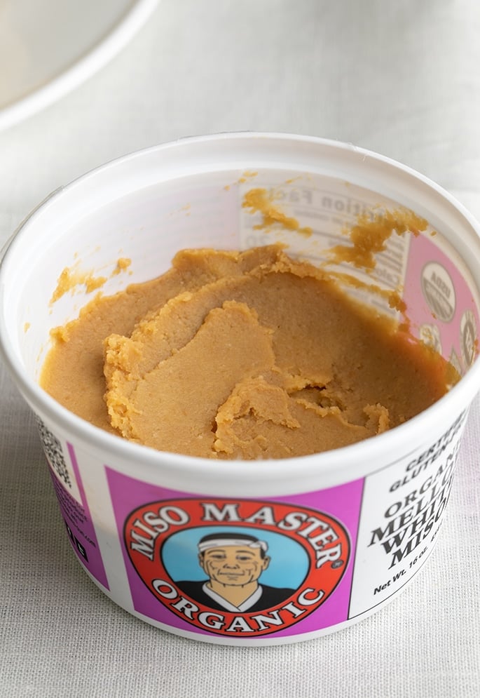 Open container of miso master organic mellow white miso paste with miso paste inside