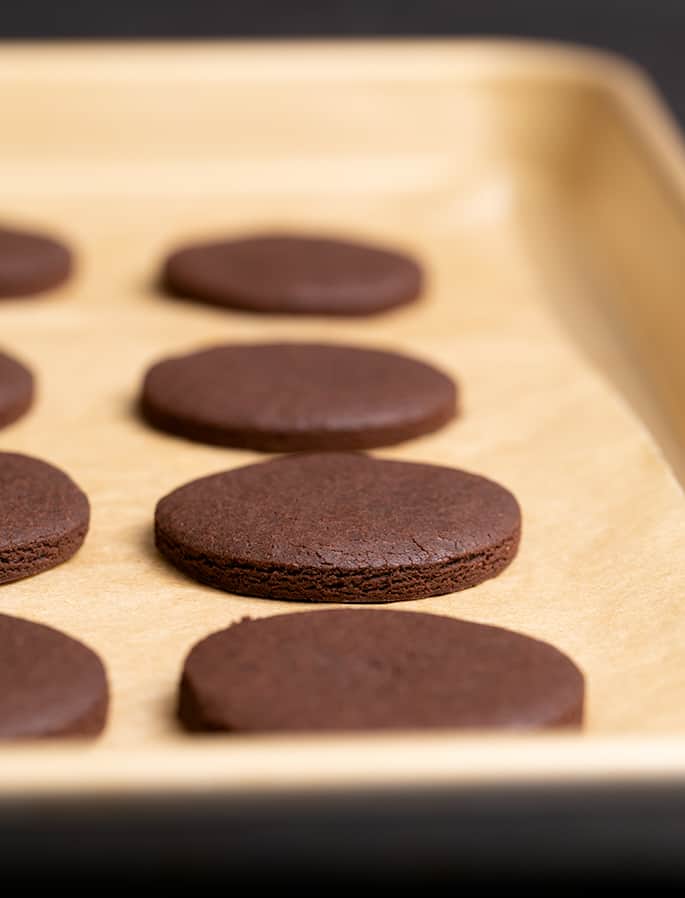 Baked round brown on brown paper on a gold colored baking tray