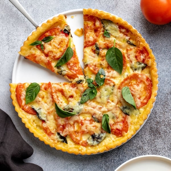 overhead image of gluten free tomato tart with slice removed